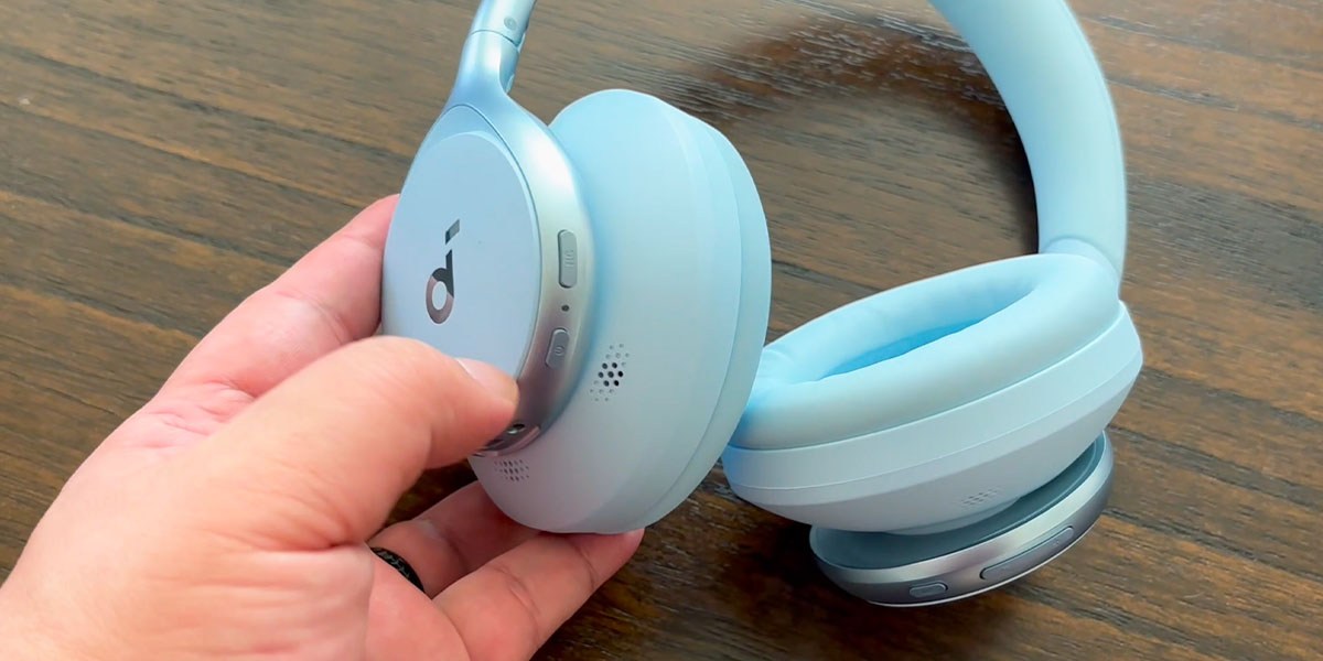 Hand holding Soundcore Space One Headphones earpiece Hand holding Soundcore Space One Headphones earpiece