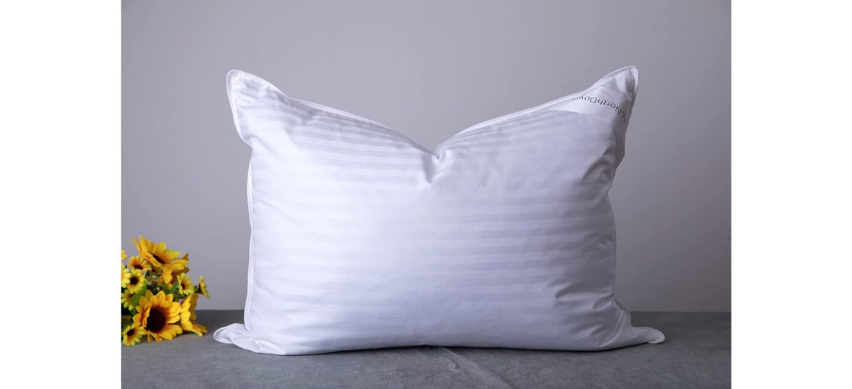 ArticNorthDown Standard Goose Down Pillow Hotel Collection Bed Pillow next to yellow flowers