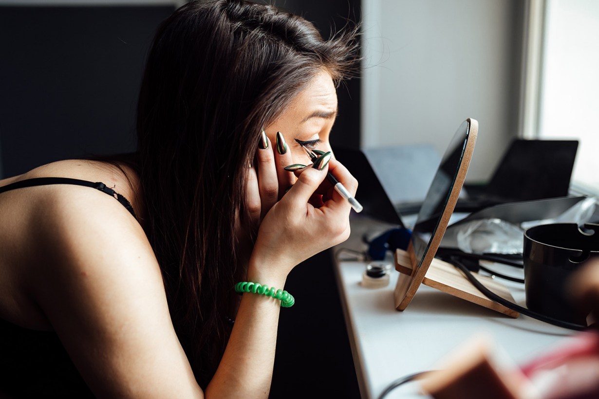 a woman putting on makeup
