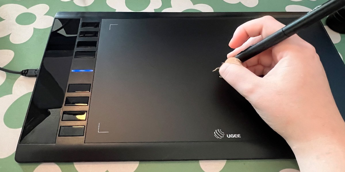 Person using the Ugee M708 Graphics Drawing Tablet  Person using the Ugee M708 Graphics Drawing Tablet