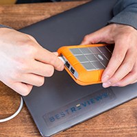 Person disconnecting cable from external hard drive