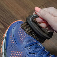 Woman spot cleaning sneakers