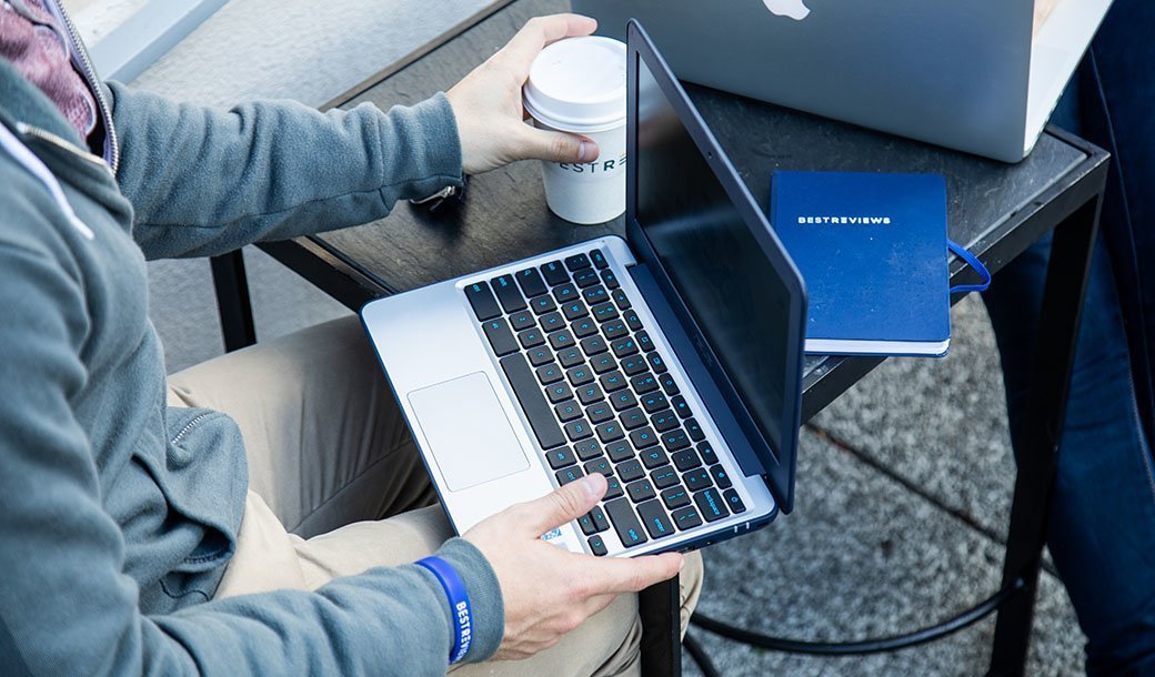 Person sitting with laptop in lap