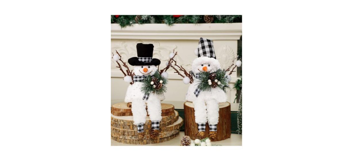 2 snowman decorations; one wearing a black top hat and another wearing a black buffalo plaid Santa hat