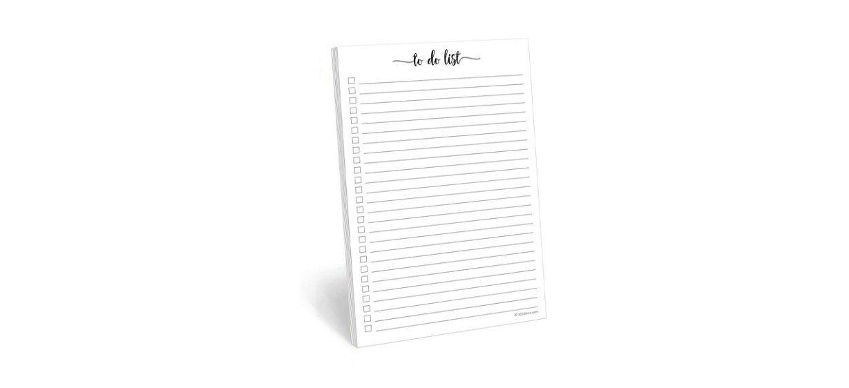 A white notepad with checkmarks next to black lines. The top reads, &quot;to do list.&quot;