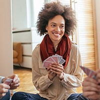 a woman playing cards with friends